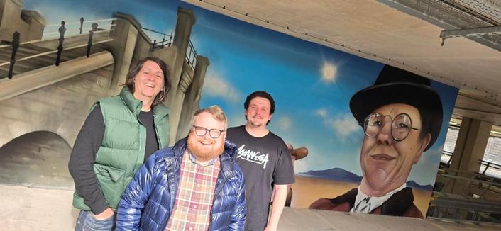 Swansea Council cabinet member Elliott King at the city’s new Amy Dillwyn mural with Ronny Oner and Ryan Lewis, of Oner Signs. Pic Swansea Council