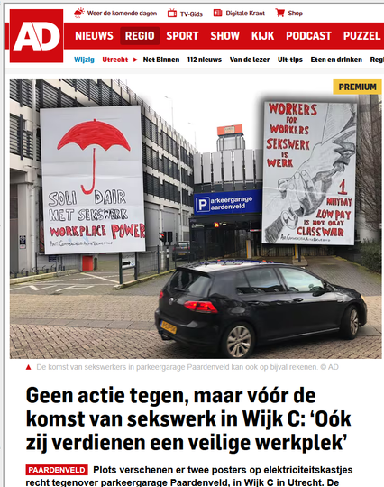 Foto van nieuws bericht in het AD nieuws met een foto van de garage met een auto die erin wil rijden en de twee posters uitgeknipt aan beide zijden geplakt