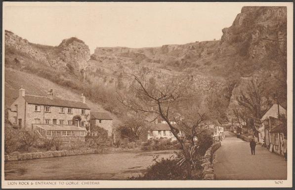Printed sepia postcard showing a view of part of the village of Cheddar, the Lion Rock and the entrance to Cheddar Gorge in Somerset.

Publisher not stated, No 36797, c.1930s.

Postally unused.

Very good condition, with very slight corner bumps.
