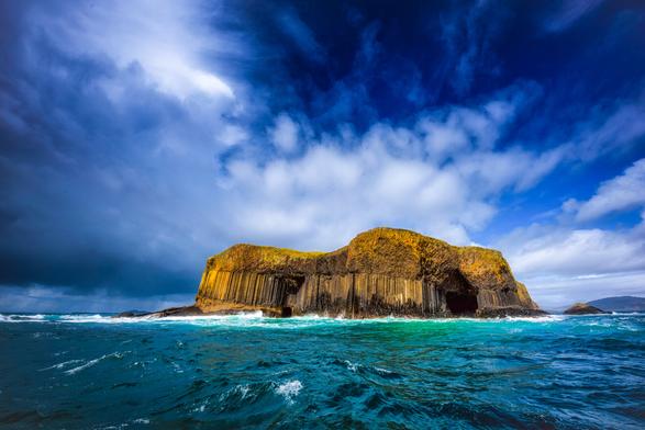 Gesamtansicht der Insel Staffa in Schottland bei dramatischem und fotogenem Wetter.