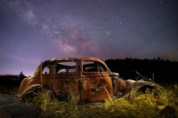 This image captures an abandoned car (late 1930s Chrysler, if I'm not mistaken) that sits in Ranch Park in Susanville, California, USA. The park was set aside from ranch land that sits adjacent to the town, hence the name. I don’t know much about this old relic but assume it was abandoned there before the area became a park. One thing I do know is that I find it very photogenic!

This image was created by capturing several images without moving the camera and artistically blending them in post-production. Fifteen separate frames were stacked together for the sky, dramatically reducing digital “noise.” I then captured several more frames by “light painting” the car with a handheld flashlight and combined the whole package together for the final image.