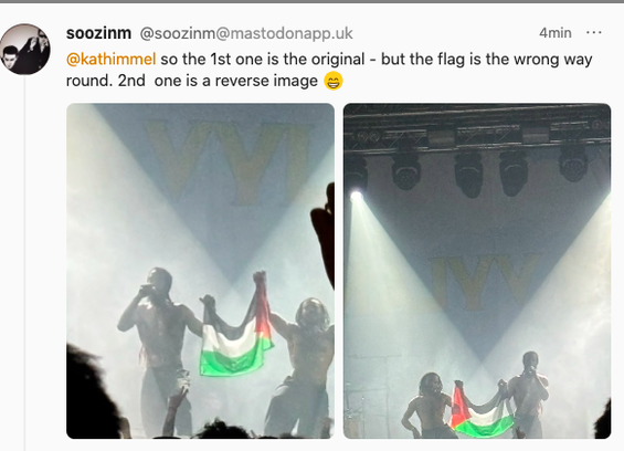 screenshot from a pal with whom i attended bob vylan's gig in glasgow.
the two members of the band stand on either side of a palestinian flag, holding it aloft beneath the stage lights.