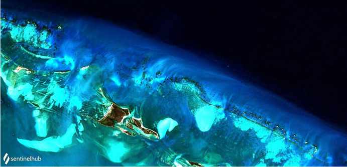 Sentinel-2 MSI image of Little Bahama Bank from 12 November 2019, showing sediments exported following the passage of a cold front over the Bahamas Banks 2 days earlier. Suspended material is carried seawards by tides through reef breaks, coalescing into a halo of sediment adjacent to the reef edge. As with hurricane transport, the sediment is steered to the right as it leaves the bank. The distance across this image is ca 25 km. The largest island is Grand Cay.