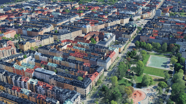 Map app 3D-view of the Vasastan area in central Stockholm. North European perimeter blocks about 7 floors tall. A large diagonal street breaks the (north-south elongated) grid, with a triangular plaza where it meets a large east-west street, with a large church on the short site of the triangle. 
A large park in the lower right of the view, with a large playground and a football field.
Bonus fact for the alt-text readers: This is where the legendary children's author Astrid Lindgren lived for the last 60 years of her life (overlooking this park), and where her creation Karlsson-on-the-Roof lives.
