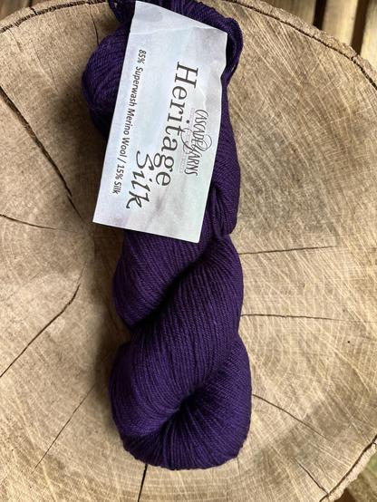 Dark purple skein of Cascade heritage silk yarn. 85% superwash merino wool and 15% silk.