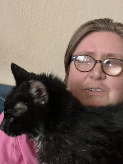 Black and white tuxedo cat lying across my chest, essentially supported by my breasts. You can see my head peeking up behind her in the photo.
Easy position for the cat to turn and bump a phone if I were holding it for speakerphone
