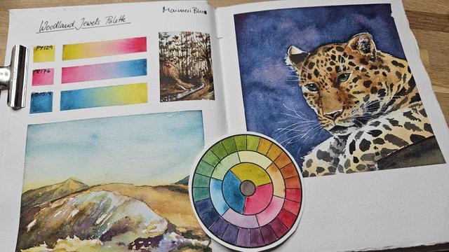 Overview over a sketchbook page with color mixes of a triad of primaries of Green Gold, Magenta and Turquoise, which produce bright jewel tones. The pages also show two landscapes and a leopard painting.