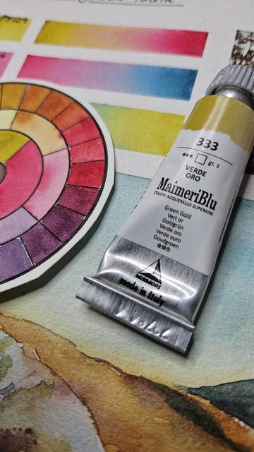 Close up of a paint tube of Green Gold from MaimeriBlu, a brand I was looking for in the video, and the mixing charts. (Don't worry... other brands carry the same pigment and they're all just as nice!)