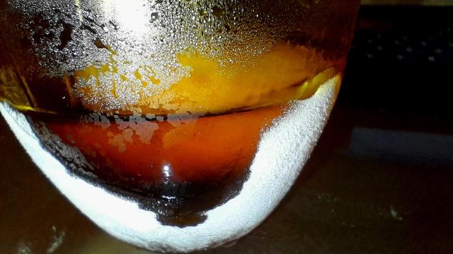 My thumb has melted a viewport into the ice condensate of the yellow glass tumbler as I sip.
The water ice sea floor has separated from the tumbler, and now floats atop a sea of slowly diluting Jägermeißter.