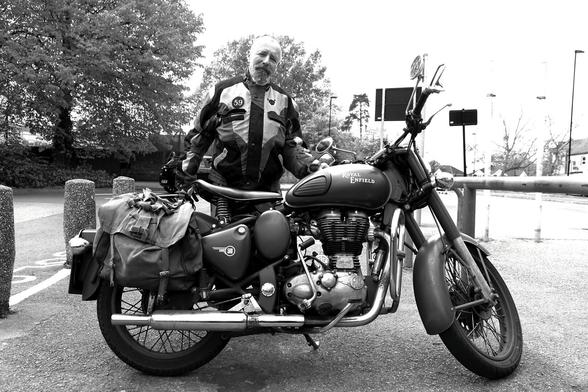 Indian Army Royal Enfield motorbike and its proud bearded owner, standing next to it