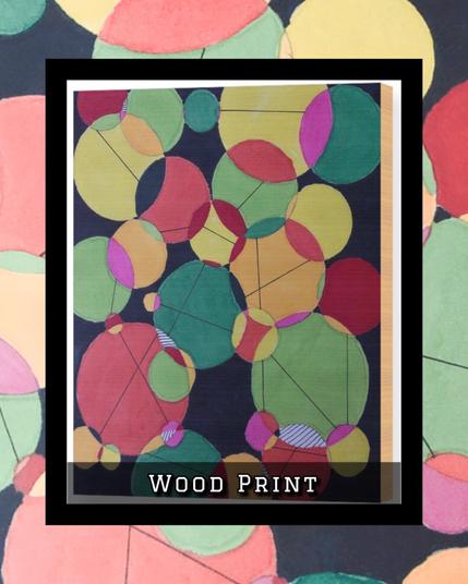 random circles in various colors overlap and crowd one another for space. On a wood print.