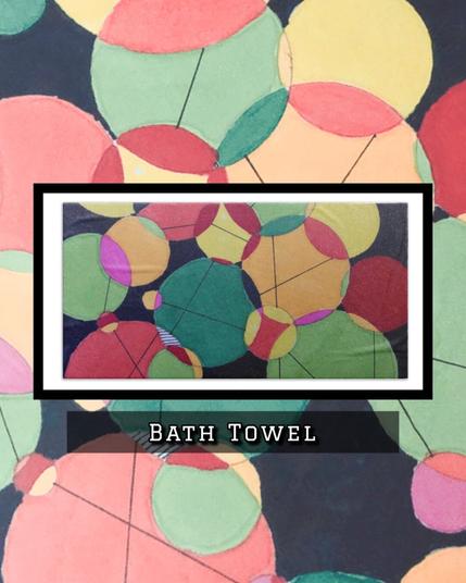 random circles in various colors overlap and crowd one another for space. On a bath towel.