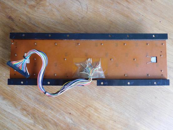 A wide shot of the back of the keyboard assembly. It doesn't appear to have ever been opened - or if it was, the previous owner was careful to replace all the screws.