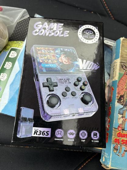 A box for a Game Boy-style retro handheld. The biggest text just says Game Console, but a closer look shows it’s something called an R36S, with no other branding. The one on the box is Atomic Purple.