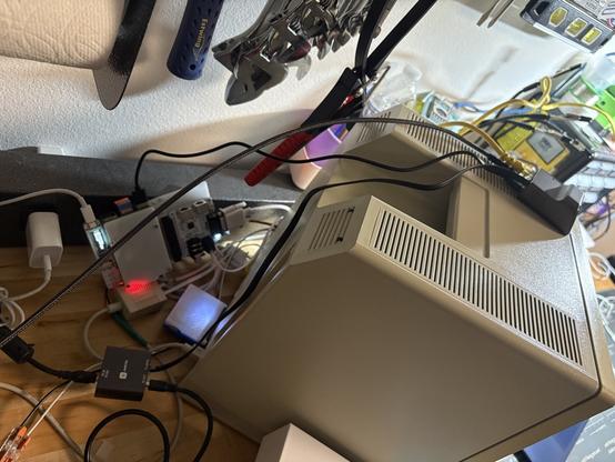 Back of Macintosh Plus showing a mess of cables going to it, the JetKVM, USB4VC and a BlueSCSI