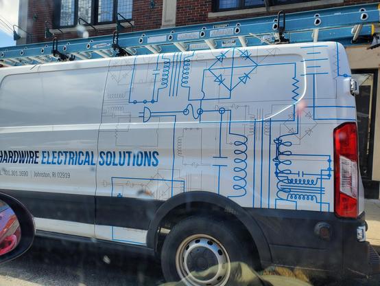 A van for an electric company with an electrical schematic painted on the side.