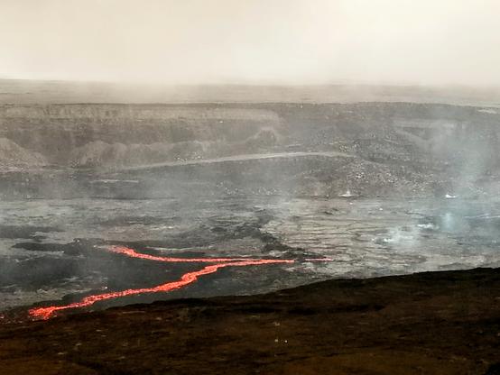 Cooling magma after a grand eruption. Looks like the confluence of two lava rivers in the crusting cauldera. There was a beautiful ceremony taking place just out of screen for the goddess Pele, singing and offerings being tossed over the crater.