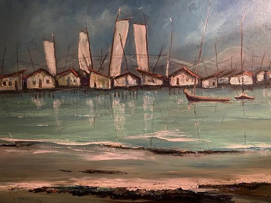 Painting of houses on stilts above a turquoise water. It is a slow moving river with waves or a bay. In the foreground are two sailing boats like fishing boats. Above the stilted houses are what appears to be sales four of them. The sky is dark blue like an incoming storm.