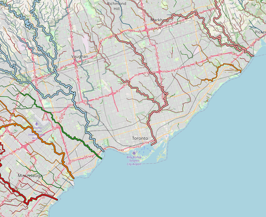 A map of Toronto and its near suburbs (Markham, Vaughan, and part of Mississauga), with baseline map from OpenStreetMap overlaid with rivers and streams. The rivers are drawn thicker further downstream, and (nearly) all river arms and streams that flow to the same river are drawn with the same colour. With this, the map effectively shows watersheds, because the finer-coloured tributary streams reach close to watershed boundaries.