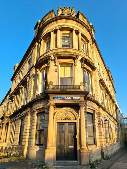 A blonde sandstone former bank building.