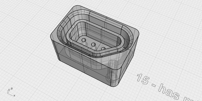 A screenshot from 3D modelling program Rhino, showing a small but complex socket for an electrical plug. It has seven pins in two rows of four and three, with an angled wall around where an eighth pin might fit. The model is semi transparent and shows some of the internal structure, including a hidden internal column where a screw might fit to secure it. There's a text label next to the model that starts "15 - has".