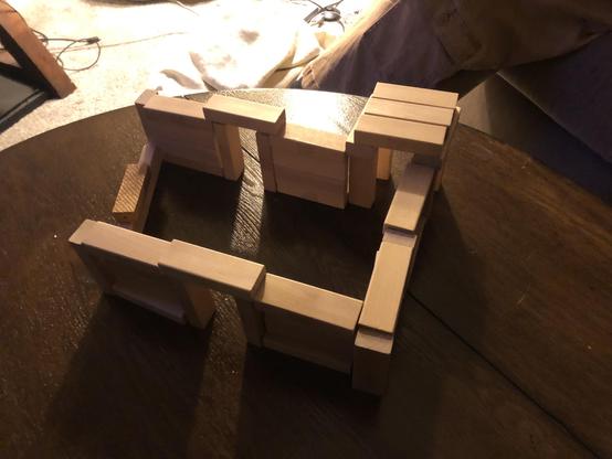 The Jenga block house from an aerial view, showing another plain doorway at the back and one low wall.
