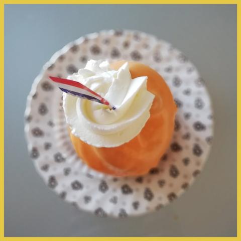orange pastry with Dutch flag and whipped cream