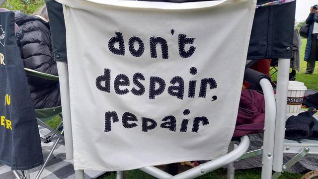 An appliqué banner than reads "don't despair. repair"