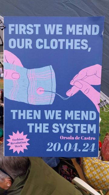 a Fashion Revolution poster that reads "First we mend our clothes, then we mend the system"
