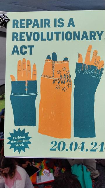 A Fashion Revolution poster that reads, "Repair is a revolutionary act"