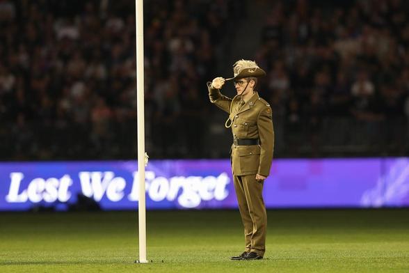 ADF soldier salutes the Australian flag before ANZAC day game between the Dockers and Crows. (Dave Woodley/AFANA)

#AFANA #AFL #fremantledockers #adelaidecrows @chris.kowald.37