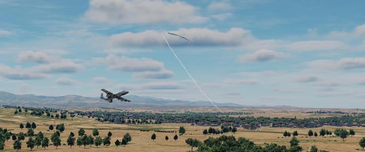 Screenshot from DCS, an A-10 is flying low down over some trees and nosing up after evading fire. A surface to air missile streak is seen having been fired from further away and hit another aircraft flying higher up. This all is against a wide expanse of somewhat deserted lands and mountains in the distance.