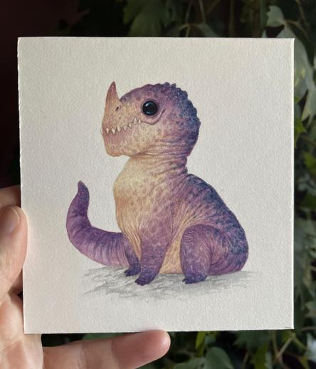 small painting of a chubby purple dragon with a pinky-cream tummy and lots of spots. He has lots of teeth and big glassy black eyes and a small horn at the end of his nose.