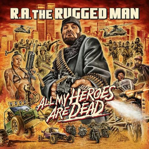 A gritty, action-packed illustrated cover showing R.A. the Rugged Man armed with guns and bullet belts in a chaotic battlefield filled with soldiers, helicopters, muscle cars, motorcycles, explosions, and a bikini-clad woman, all set against a fiery orange cityscape with the Twin Towers in the background.