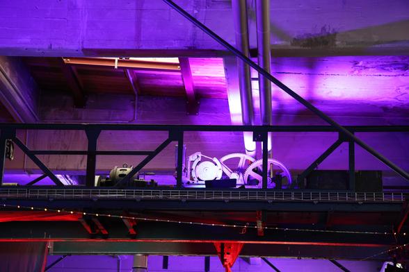 Some mechanics with two big gear wheels lit in purple. Not sure what this is.