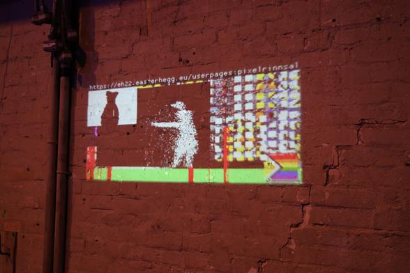 Pixelflut on a wall, including Bad Apple and a pride flag.