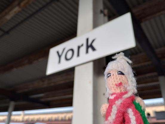 Puppet stands erect and proud in front of the York station sign, having successfully penetrated The North.