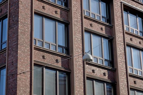 A close-up brick build front, with rectangular windows which seem to repeat ad aeternam.