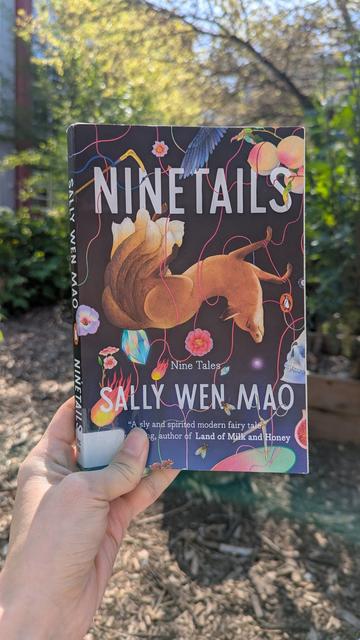 Front cover of Ninetails: Nine Tales by Sally Wen Mao, a collection of short stories based on mythologies about fox spirits.

The cover illustration is of an upside down red fox with nine tails, surrounded by flowers, peaches, and bird wings against a dark blue background.