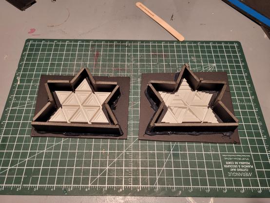 The 3D printed maple leaf sculptures inside foam core mold boxes.