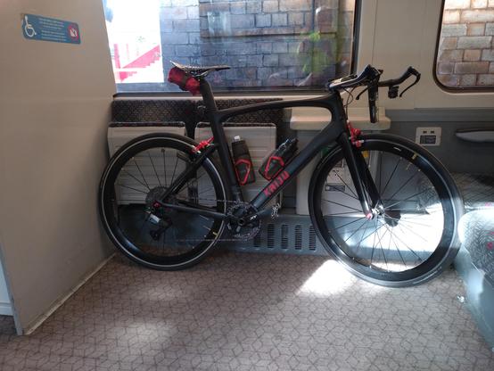 Black & red bike on a train