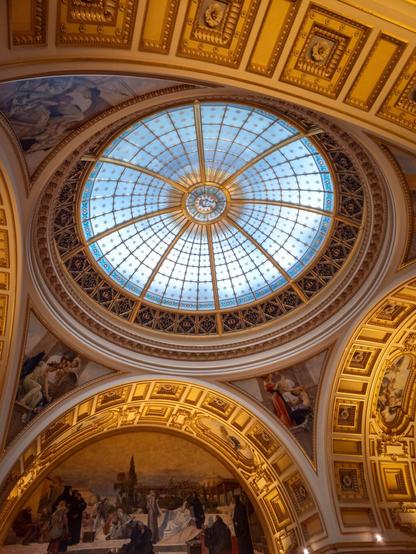 A ceiling in a beautiful building from the 1800s.