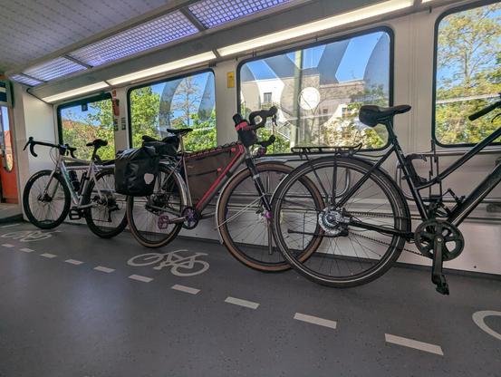 bikes against a railing in a train car