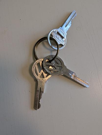 3 silver keys on a key chain. 2 of the keys have the Volkswagen "VW" symbol carved into them.