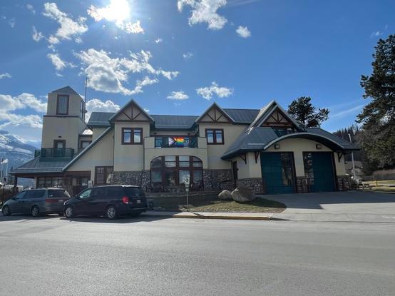 New emergency services building in Jasper with a backlit pride flag on the balcony
