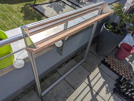 Partially built vertical planter bed. Scaffold made of aluminium profiles. Planter cup made of stainless steel sheet metal angles and a wooden plank.