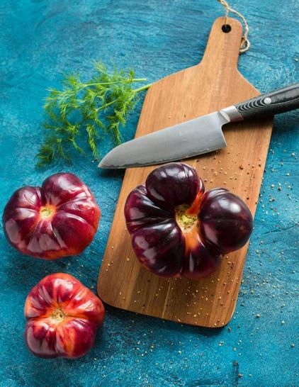 black handle knife with vegetables