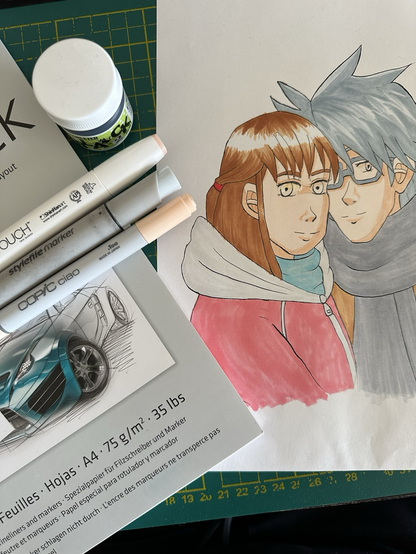 Photo of a layout pad, three alcohol markers, a tub of ink, and a sheet of paper with a manga-esque drawing on it. The drawing shows a teenage girl with reddish-brown hair and a boy with greyish-blue hair and glasses who leans on her. The colouring is unfinished.