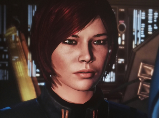 My Commander Shepard from Mass Effect 3. She is a white woman with green eyes and chin-length dark auburn hair.