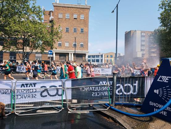 Runners passing under a shower to cool them